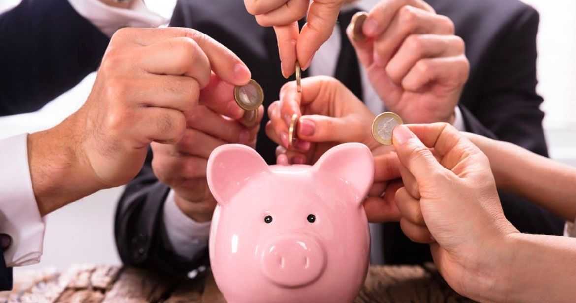 Dropping coins in a piggy bank